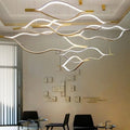 https://cdn.shopify.com/s/files/1/0736/8795/7790/files/modern-simple-brass-waving-chandelier-for-livingdining-roomkitchen-island-merlin-lamps-10.jpg?v=1765407442