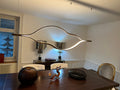 https://cdn.shopify.com/s/files/1/0736/8795/7790/files/modern-simple-brass-waving-chandelier-for-livingdining-roomkitchen-island-merlin-lamps-11.jpg?v=1765407444