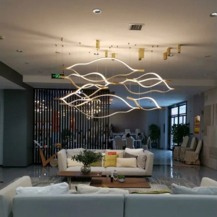 https://cdn.shopify.com/s/files/1/0736/8795/7790/files/modern-simple-brass-waving-chandelier-for-livingdining-roomkitchen-island-merlin-lamps-3.jpg?v=1767690874