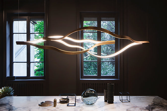 https://cdn.shopify.com/s/files/1/0736/8795/7790/files/modern-simple-brass-waving-chandelier-for-livingdining-roomkitchen-island-merlin-lamps-6.jpg?v=1765407435
